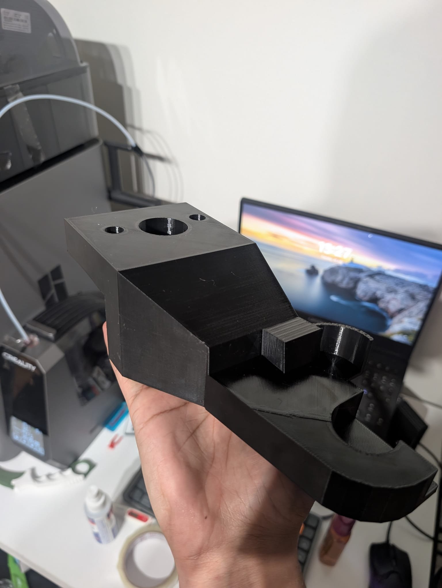 Large black custom 3D printed part held in hand at Axis Prototyping